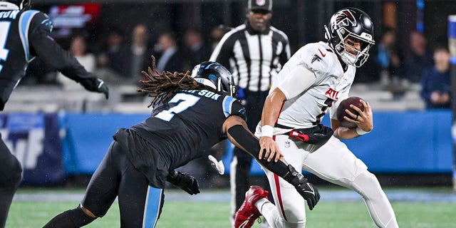 Shaq Thompson (7) of the Carolina Panthers tackles Marcus Mariota (1) of the Atlanta Falcons during the first quarter at Bank of America Stadium Nov. 10, 2022, in Charlotte, N.C. 