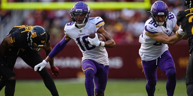 Justin Jefferson (18) of the Minnesota Vikings carries the ball against the Washington Commanders during the second half at FedEx Field Nov. 6, 2022, in Landover, Md. 
