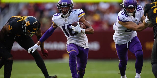 Justin Jefferson (18) of the Minnesota Vikings carries the ball against the Washington Commanders during the second half at FedEx Field Nov. 6, 2022, in Landover, Md. 