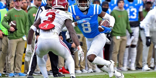 Malik Heath (8) of the Mississippi Rebels carries the ball against Terrion Arnold (3) of the Alabama Crimson Tide during the first half at Vaught-Hemingway Stadium Nov. 12, 2022, in Oxford, Miss.