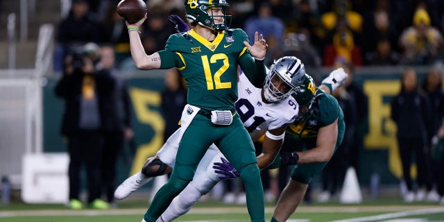 Blake Shapen (12) of the Baylor Bears throws under pressure from Felix Anudike-Uzomah (91) of the Kansas State Wildcats in the first half at McLane Stadium Nov. 12, 2022, in Waco, Texas.