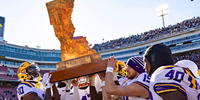 The LSU Tigers carry the trophy named The Boot after a win against the Razorbacks on Nov. 12, 2022, in Fayetteville, Arkansas.