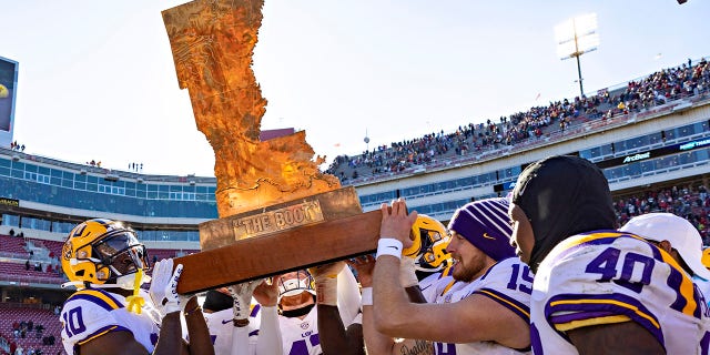 The LSU Tigers carry the trophy named The Boot after a win against the Razorbacks on November 12, 2022 in Fayetteville, Arkansas.