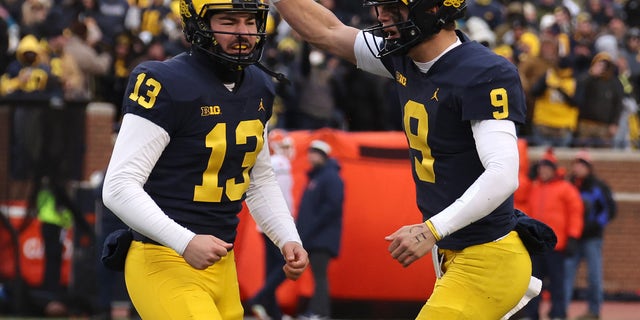 Jake Moody (13) of the Michigan Wolverines celebrates his game-winning field goal with J.J. McCarthy (9) to beat the Illinois Fighting Illini 19-17 at Michigan Stadium Nov. 19, 2022, in Ann Arbor, Mich.