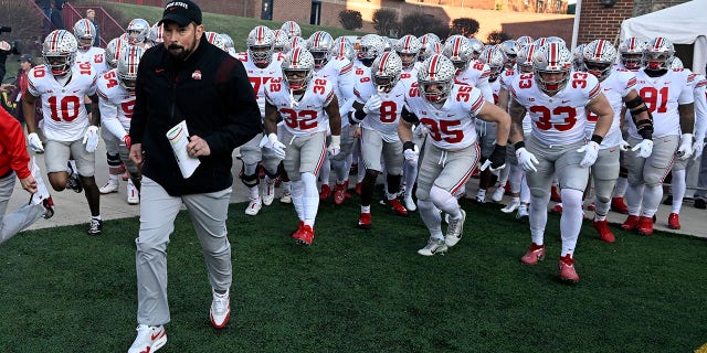 Head coach Ryan Day of the Ohio State Buckeyes leads his team onto the field before the game against the Maryland Terrapins at SECU Stadium on November 19, 2022 in College Park, Maryland.