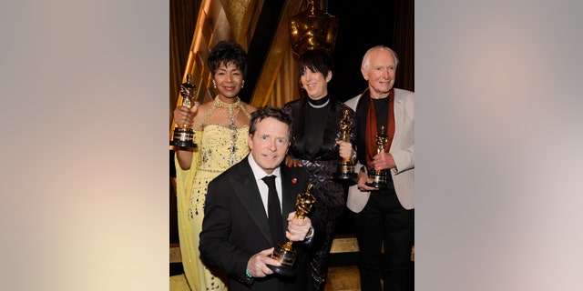 Euzhan Palcy, Michael J. Fox, Diane Warren, and Peter Weir pose with their awards they earning Saturday evening.