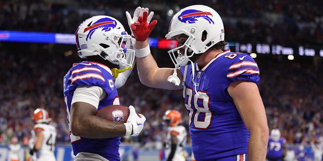 Stefon Diggs and Dawson Knox of the Buffalo Bills celebrate after Diggs' touchdown against the Cleveland Browns on Nov. 20, 2022, in Detroit, Michigan.