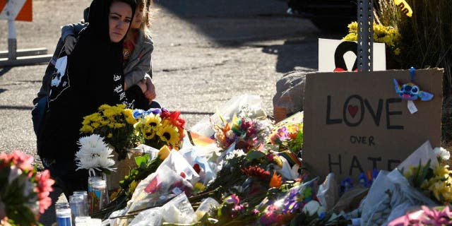 A woman and her daughter pay their respects at a makeshift memorial near Club Q in Colorado Springs, Colorado, on Sunday.