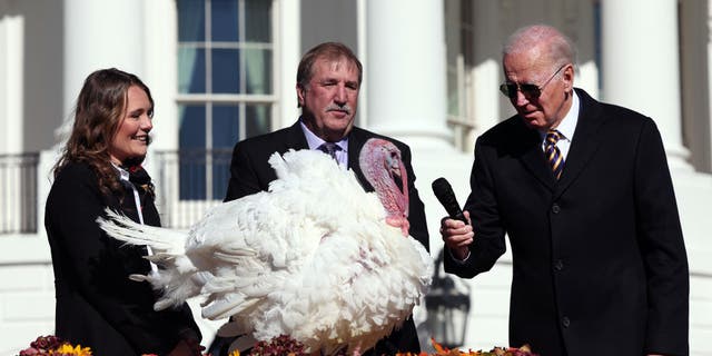 President Biden is joined by National Turkey Federation Chairman Ronnie Parker and Alexa Starnes, daughter of the owner of Circle S Ranch, as he pardons the turkey Chocolate, on the South Lawn of the White House, Nov. 21, 2022.