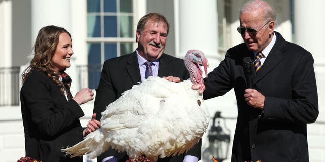 President Biden pardons Chocolate, the national Thanksgiving turkey, as he is joined by 2022 Turkey National Federation President Ronnie Parker and Alexa Starnes, daughter of Circle S Ranch owner, on the South Lawn of the House Blanche on November 21, 2022, in Washington, DC