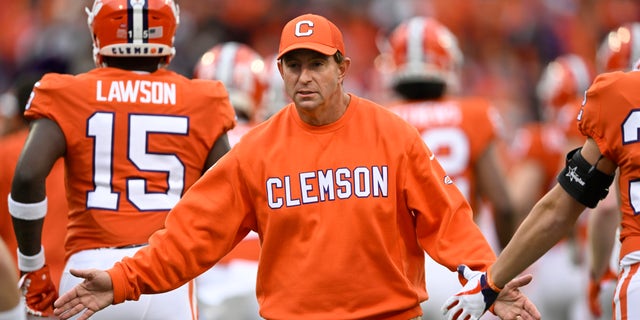 Head coach Dabo Swinney of the Clemson Tigers high-fives his team as players run onto the field before a game against the Miami Hurricanes at Memorial Stadium Nov. 19, 2022, in Clemson, S.C. 