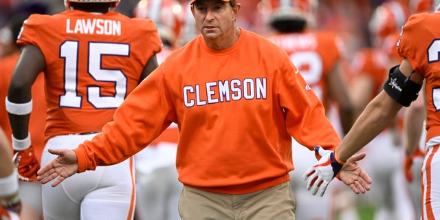 Head coach Dabo Swinney of the Clemson Tigers high-fives his team as players run onto the field before a game against the Miami Hurricanes at Memorial Stadium Nov. 19, 2022, in Clemson, S.C. 