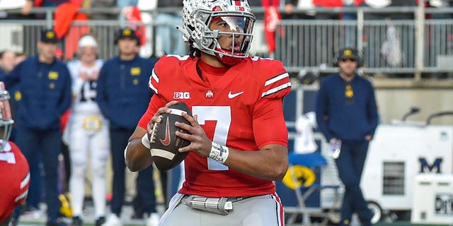 CJ Stroud of the Ohio State Buckeyes looks to pitch against the Michigan Wolverines at Ohio Stadium on November 26, 2022 in Columbus.