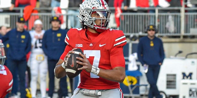 CJ Stroud of the Ohio State Buckeyes looks to pitch against the Michigan Wolverines at Ohio Stadium on November 26, 2022 in Columbus.