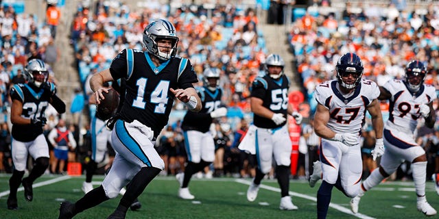 Sam Darnold of the Panthers runs with the ball against the Denver Broncos at Bank of America Stadium on Nov. 27, 2022, in Charlotte, North Carolina.