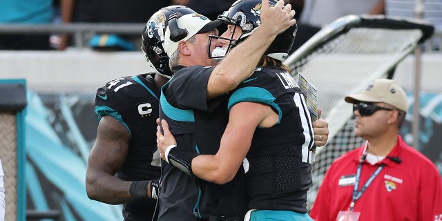 Trevor Lawrence #16 of the Jacksonville Jaguars celebrates a play with head coach Doug Pederson during the second half of the game against the Baltimore Ravens at TIAA Bank Field on November 27, 2022 in Jacksonville, Florida.