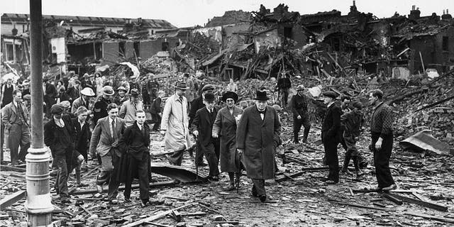 British Prime Minister Winston Churchill (center) inspecting air raid damage in Battersea, South London, during the Blitz, Sept. 10, 1940.