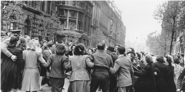May 8, 1945: Some of the huge crowd who were in Whitehall, London, to hear Churchill's speech on VE Day are shown in this image.