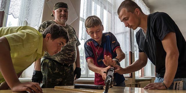 In a school in Khartsyzk in eastern Ukraine on June 17, 2015, teenagers learn the basics of war, as the conflict with Ukrainian forces continues.