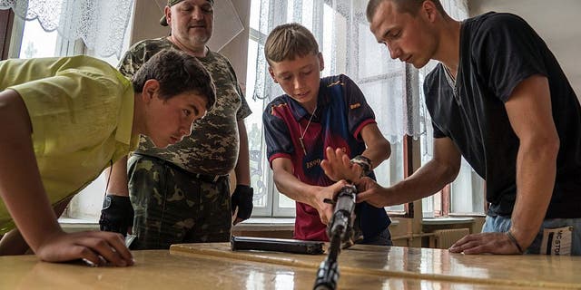 In a school in Khartsyzk in eastern Ukraine on June 17, 2015, teenagers learn the basics of war, as the conflict with Ukrainian forces continues.