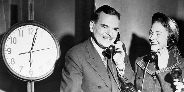 Making an 11-hour bid to win undecided voters to his side, Governor Thomas E. Dewey, a candidate for re-election as Empire State chief executive, began a long day of broadcasts and appearances at the television at station WOR-TV at 6 a.m. on November 6, 1950. The schedule called for an 18-hour day for the governor, pictured answering a phone while Mrs. Dewey answered other phones. 