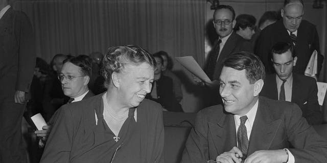 Eleanor Roosevelt, member of the U.S. delegation to the U.N., chats with Mr. E. Davies, M.P. and member of the British delegation, during the meeting of the Social, Cultural and Humanitarian Committee of the U.N. In an address before the 57-nation committee, Mrs. Roosevelt accused the Soviet states of "poisoning the wells of international friendship" with a flood of propaganda against the U.S.