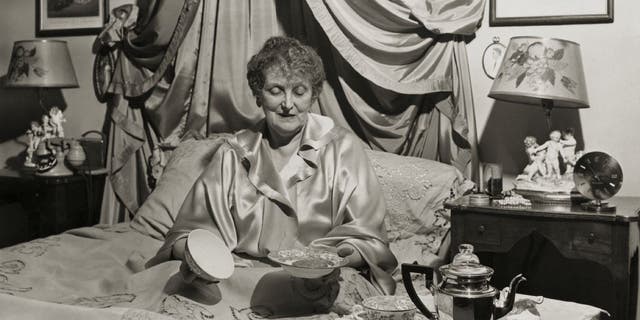 Etiquette guru and columnist Emily Post continued to write about etiquette and established an institute to teach the art in 1946. Here she is enjoying a light meal in bed in this undated photo.
