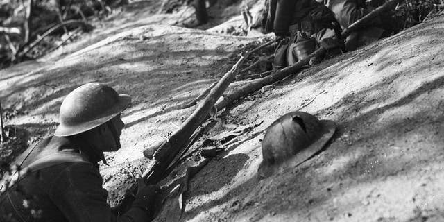 Close-up of American soldiers of the 18th Infantry, 1st Division holed up on the side of Hill 240 in the Ardennes, during the Meuse-Argonne Offensive, France, Oct. 11, 1918. 