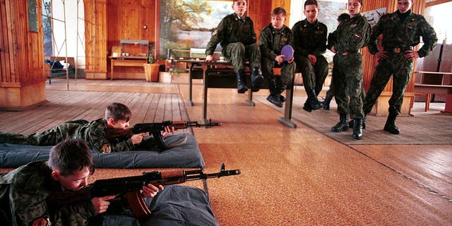 Inside the facility, children learn to shoot a rifle March 5, 1999 outside Moscow. Russian children's units are made up of children who have been abandoned by their parents.