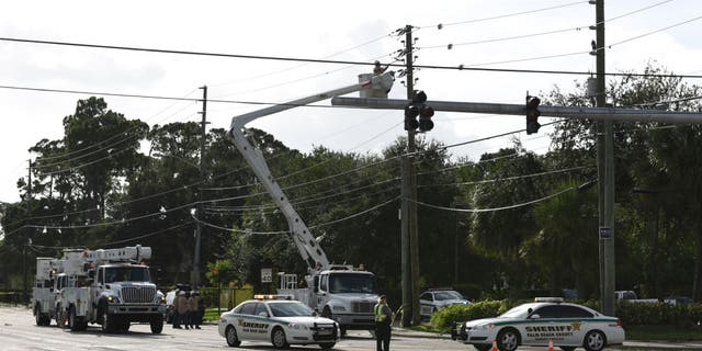 Florida Power, Light Co. (FPL) crews work on downed power lines.