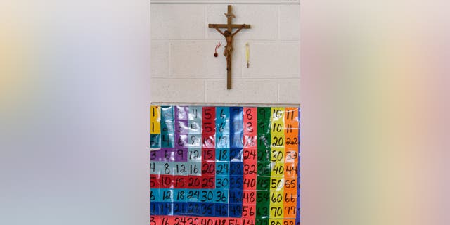 DENVER, CO - JANUARY 23: A crucifix hangs above a multiplication table in the fourth-grade class at St. Francis de Sales Catholic School on Tuesday, January 23, 2018. (Photo by AAron Ontiveroz/The Denver Post via Getty Images)