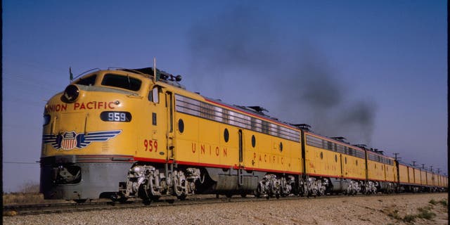 Union Pacific diesel locomotive train, Cajon Pass near Ono, California, 1964. Sprawling distances across North America and a confusing patchwork of local timing methods encouraged railroads to adopt time zones in 1883 .