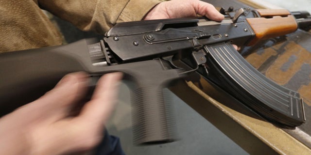 A bump stock is installed on an AK-47 and its movement is demonstrated at Good Guys Gun and Range on February 21, 2018, in Orem, Utah. 