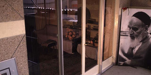 A photo of Ayatollah Khomeini leaning against a wall on the balcony of his former residence in Jamaran, north of Tehran, Iran, on January 2, 1994. The building is preserved as a museum.