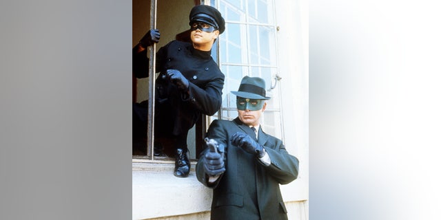 Bruce Lee (1940-1973), Chinese American actor and martial artist, and Van Williams, US actor, both in costume, in a publicity portrait issued for the US television series, 'The Green Hornet', USA, circa 1967. The action adventure series starred Lee as 'Kato', and Williams as 'The Green Hornet'. 