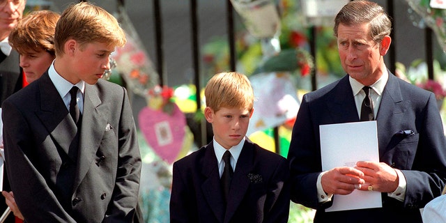 Prince William and Prince Harry with then Prince Charles holding a funeral program at Westminster Abbey For The Funeral Of Diana, Princess Of Wales, in Sept. 1997.