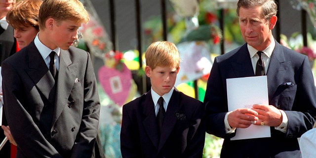 Prince William and Prince Harry with then Prince Charles holding a funeral program at Westminster Abbey For The Funeral Of Diana, Princess Of Wales, in Sept. 1997.