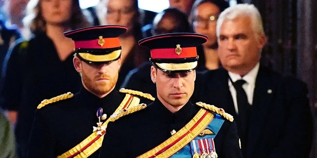 Queen Elizabeth's grandchildren (L-R) Britain's Prince Harry, Duke of Sussex and Britain's Prince William, Prince of Wales, standing vigil around her coffin on Sept. 17, 2022. Britain's longest-reigning monarch passed away on Sept. 8 at age 96.