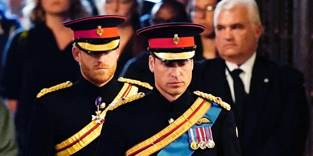 Queen Elizabeth's grandchildren (L-R) Britain's Prince Harry, Duke of Sussex and Britain's Prince William, Prince of Wales, standing vigil around her coffin on Sept. 17, 2022. Britain's longest-reigning monarch passed away on Sept. 8 at age 96.