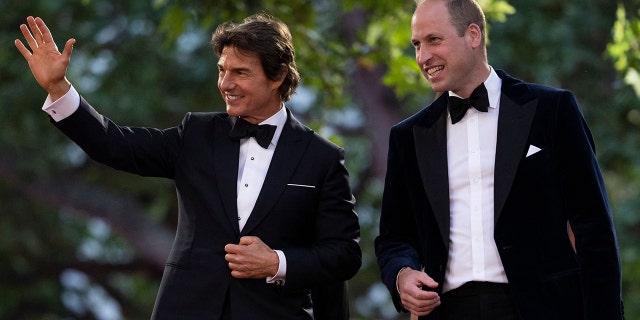 Britain's Prince William, right, is accompanied by Tom Cruise, left, as he arrives for the U.K. premiere of ‘Top Gun: Maverick’ in London on May 19, 2022. 