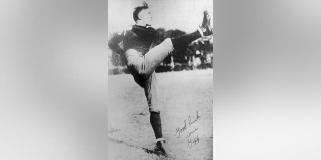 George Gipp, football player for Notre Dame, is shown here in action. The autograph reads, "Good luck from Gipp."