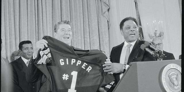President Reagan holds a shirt given to him by former baseball star Willie Mays after Reagan spoke to campaign workers at the White House. "Gipper, #1," refers to a movie role Reagan played during his Hollywood days, in which he was a football star named George Gipp.