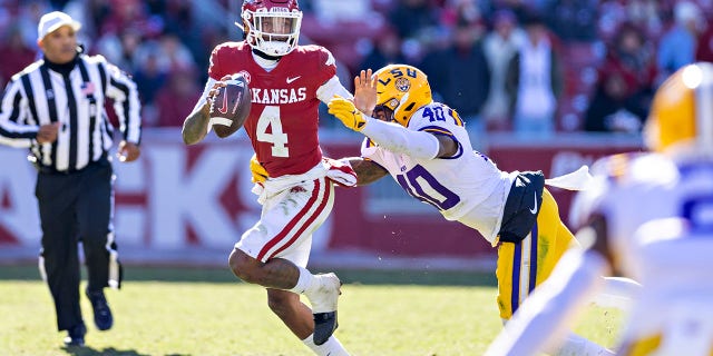 Arkansas' Malik Hornsby is tackled by Harold Perkins Jr. of the LSU Tigers at Donald W. Reynolds Razorback Stadium on Nov. 12, 2022, in Fayetteville.