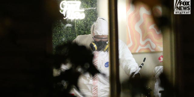 Investigators in hazmat suits examine the scene of a quadruple homicide near the University of Idaho campus.  