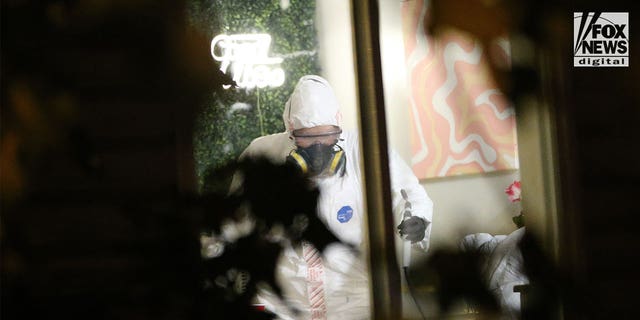 Investigators in hazmat suits examine the scene of a quadruple homicide near the University of Idaho campus. 