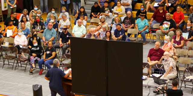 Residents of Pahala, Hawaii, a remote town of about 1,400 on the south side of the Big Island, listen as Civil Defense Administrator Talmadge Magno speaks about the recent activity on Mauna Loa at the local gymnasium on Thursday, Oct. 27, 2022.