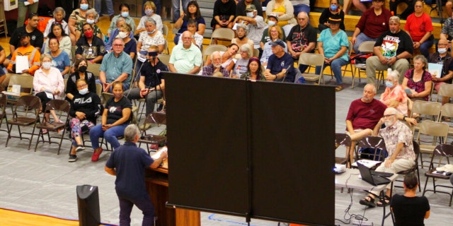 Residents of Pahala, Hawaii, a remote town of about 1,400 on the south side of the Big Island, listen as Civil Defense Administrator Talmadge Magno speaks about the recent activity on Mauna Loa at the local gymnasium on Thursday, Oct. 27, 2022.