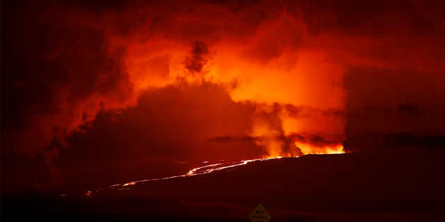 A river of lava flows down from Mauna Loa, Monday, Nov. 28, 2022, near Hilo, Hawaii. Mauna Loa, the world's largest active volcano erupted Monday for the first time in 38 years.