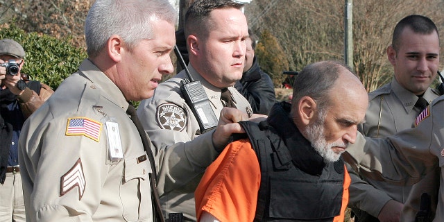 Gary Michael Hilton is escorted to a police car after pleading guilty to murdering hiker Meredith Emerson Thursday, Jan. 31, 2008, in Dawsonville, Ga. Emerson was kidnapped while hiking in the north Georgia mountains on New Year's Day 2008.