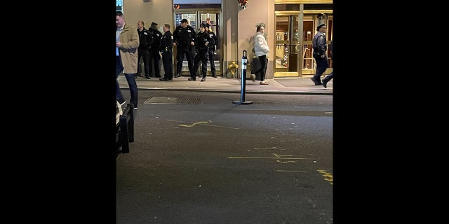 Police stand outside the New York City Hyatt after possible explosives were found.